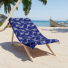 Beach towel placed on top of a wooden chair in a beach sand
