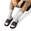 A man wearing PU Slide Sandals in black