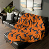  Fleece Blanket | Vibrant Orange | On top of the sofa