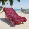 Beach towel on top of a wooden chair in a beach sand